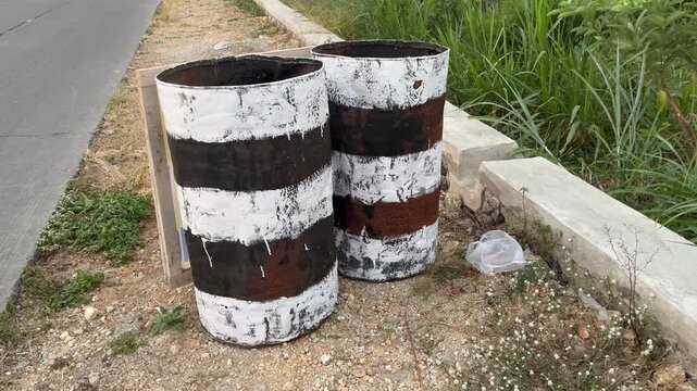 Asphalt Bitumen Drums Stacked at Road Construction Site