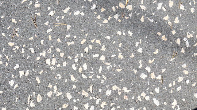 Suelo gris de terrazo con peque&ntilde;as piedras blancas incrustadas