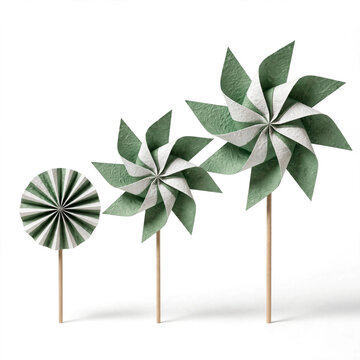 Sage green paper pinwheels on wooden sticks, decorative craft windmills in different sizes, minimalist party decor on white background