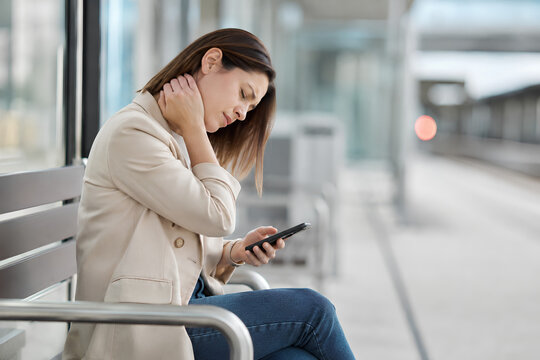 Tech neck pain from poor smartphone posture while commuting