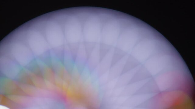 Soft focus lights of a carnival ride at night