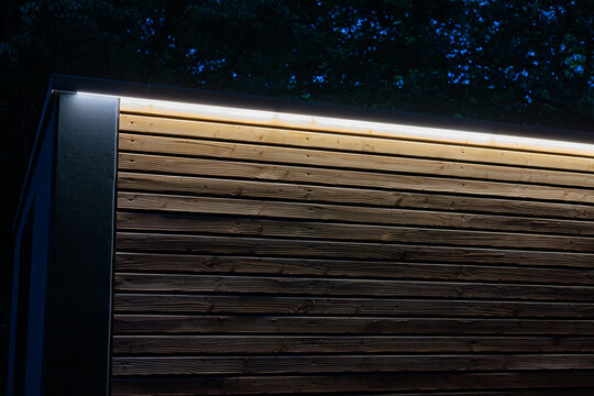 Illuminated wooden facade at night in the park