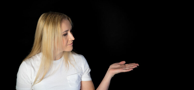 Photo of charming blonde shiny young woman dressed white t-shirt finger forehead looking empty space smiling isolated black background