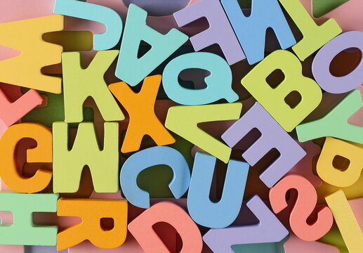 Colorful wooden alphabet letters background and texture, top view, design element