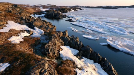 Fototapeta premium A subarctic coastal landscape with rocky shoreline and frozen sea