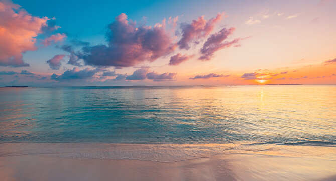 Dreamy panoramic pastel sunset calm sea soft pink clouds tropical beach shore evening glow. Peaceful summer seascape nature landscape. Meditation wellbeing wallpaper romantic coastal banner
