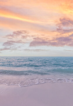 Soft pastel sunset tranquil sea gentle waves dramatic tropical beach shore glowing sky. Peaceful summer seascape nature landscape. Meditation wellbeing backdrop warm coastal abstract view background
