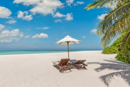 Beautiful panoramic sea sand sky. Tropical relax beach sunny summer island landscape. Love couple chairs umbrella palm leaves romantic coast. Luxury travel destination. Honeymoon vacation best tourism