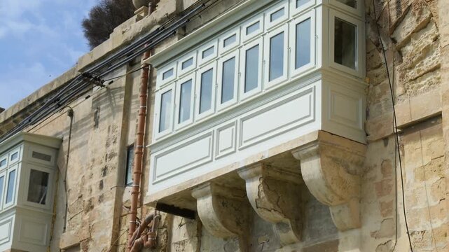 ornate white gallarija balcony rests on carved stone corbels valletta townhouse traditional wooden balcony detail maltese balcony valletta architecture traditional maltese window baroque facade