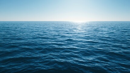 Fototapeta premium Calm blue ocean surface with gentle waves and clear sky