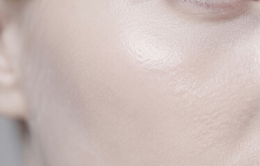 Naklejka premium Extreme macro close up of smooth fair skin texture and healthy glowing glass skin