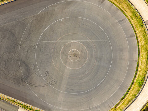 Aerial View of a Circular Vehicle Testing Facility Track During a Bright Day
