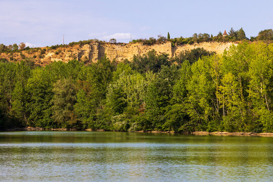 Limestone cliffs of Clermont-le-Fort overlooking the Ari&egrave;ge river, seen from the Lac du Ramier de la Riverotte
