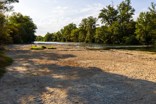 Partially dried-up course of the Ari&egrave;ge river in summer 2026, marked by severe heat waves and significant drought, seen from the Ramier de la Riverotte at Clermont-le-Fort