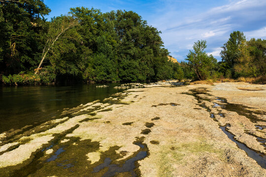 Partially dried-up course of the Ari&egrave;ge river in summer 2026, marked by severe heat waves and significant drought, seen from the Ramier de la Riverotte at Clermont-le-Fort