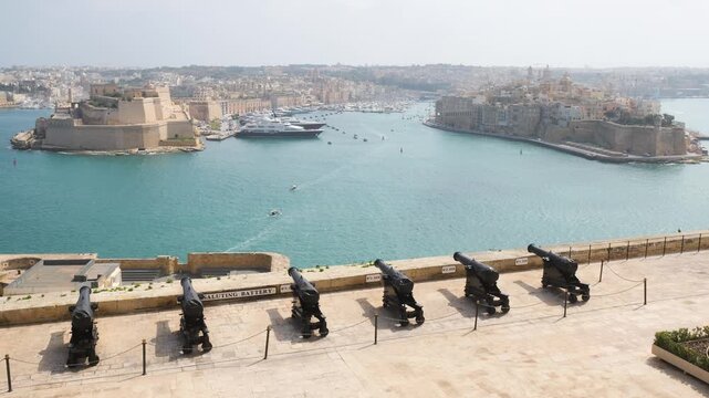 saluting battery cannons line the upper barrakka gardens overlooking grand harbour superyacht docked below valletta cannons grand harbour view malta artillery heritage historic cannon row