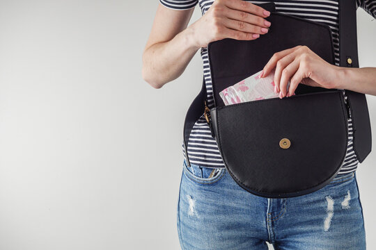 young girl takes out a sanitary napkin from her handbag, hygiene concept