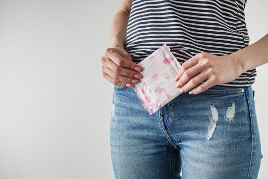 young girl holding a sanitary napkin hygiene concept