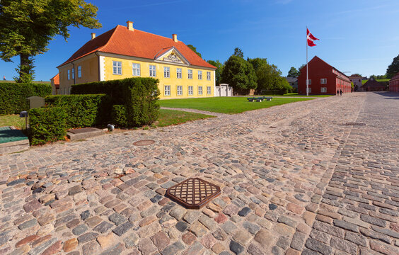 Historic Yellow Building with Danish Flag in Copenhagen Denmark