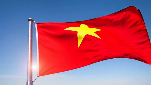 Vietnam national flag waving in the wind with a bright blue sky background on a sunny day