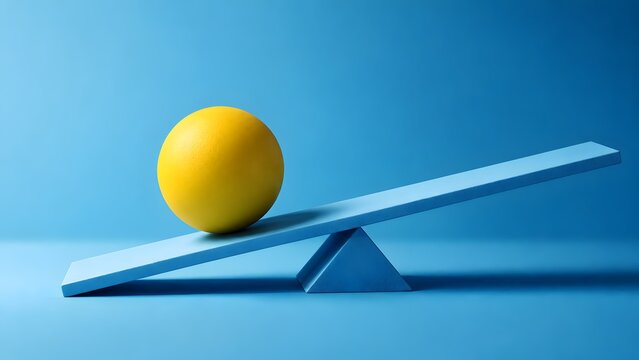 Yellow ball on tilted blue wooden seesaw against blue background. Concept of business risk management, financial leverage, and market instability.