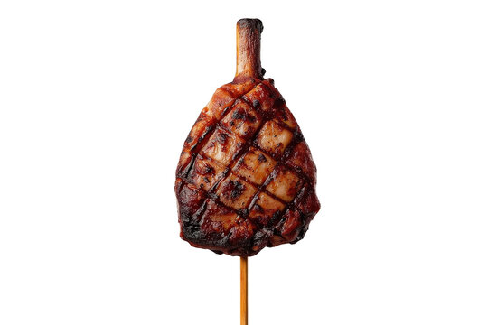 Thick grilled meat cut on a stick with crosshatched sear marks