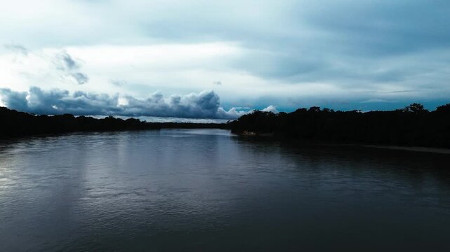 Wide Tropical River in Ecuador Amazon Rainforest with Dark Water, Dense Forest Banks, Cloudy Sky, Remote Wilderness, South American Nature Travel and Jungle Waterway Landscape