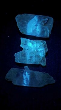 Macro of natural gypsum crystals showing 365nm UV blue fluorescence & 2s greenish phosphorescence afterglow in total darkness. Ideal for physics, mineralogy & geology science education.