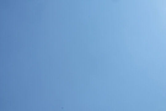 Clear blue sky background with no clouds during a bright sunny day.