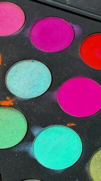 Colorful professional makeup palette with bright cosmetic shades in close up, beauty products, creative makeup, color selection, salon tools.
