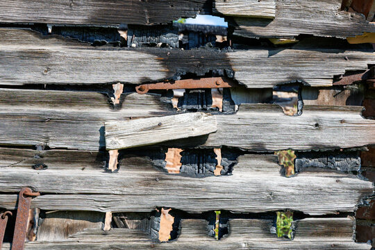 Burnt weathered wooden barn wall texture closeup