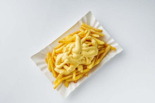 delicious crispy golden french fries with cheese on a white background