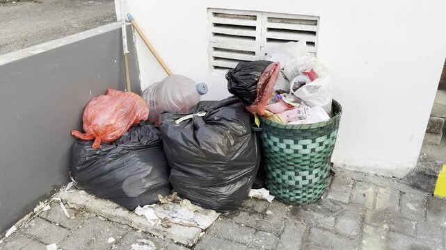 Heaps of plastic garbage bags piled up on the residential street