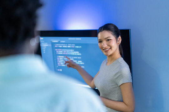 Female developer presents AI-assisted code solutions, demonstrating human-AI collaboration and productivity enhancement through intelligent programming assistance.