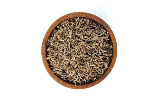 Caraway seeds in small wooden bowl isolated on white background