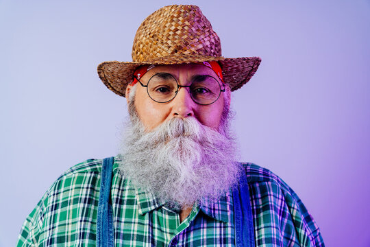Senior old man with gray beard portrait in studio