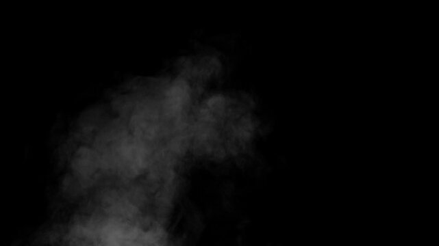 Water vapor tends upward. White Steam rises from a large pot that is behind the scenes. Black background