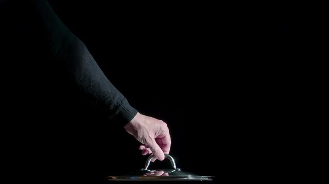 Hot Steam from under the Covers. White Clouds of steam rise from under the raised cap on a black background