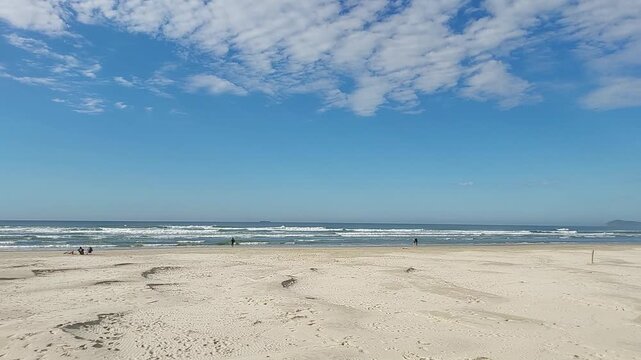 Beach and ocean waves between praia do luz and barra da ibiraquera