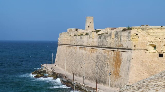 sentry turret perches on fort st elmo bastion wall close view limestone rampart rising above the sea fort ricasoli star fort knights of malta fortress valletta fortification harbour entrance fort