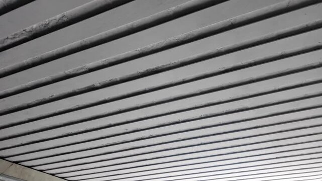 Aesthetic cinematic view of slat aluminum suspended ceiling in modern tunnel