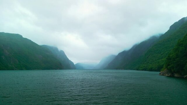 Serene Norwegian fjord landscape with misty mountains and calm waters, showcasing the gradual transition of the scene across three connected frames