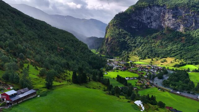 drone view of Flam village and Flam railway in Norway, Norwegian village on the shore of Aurlands fjord, idyllic Scandinavian nature, river Moldo flows in Flam valley, travel and tourism in Norway