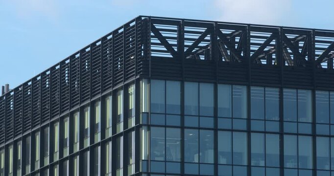 City office building metal and large glass windows blue sky