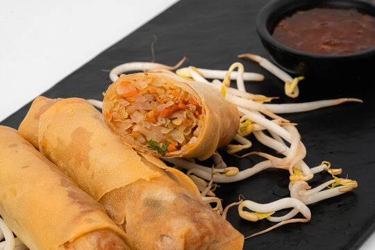 Close Up Fried Spring Roll on Black Plate