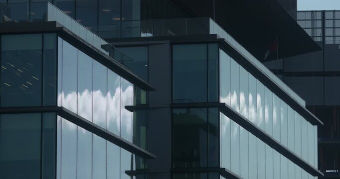 Modern architecture office building blue sky reflections large glass windows angular box design