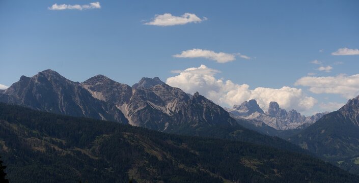 Majestic scenery of rough mountain ridge near grassy hills 