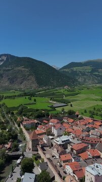 Vertical Drone Orbit Over Glurns Medieval Walls and Alpine Valley Italy