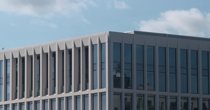 Modern office city architecture building long windows symmetrical pattern blue sky