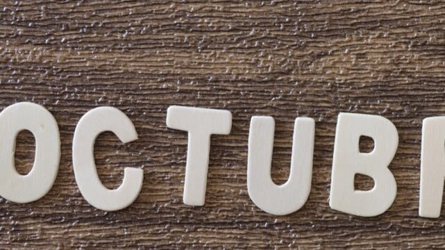 Text made of wooden letters spelling out the month of October.